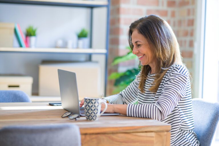 Educator Smiling While Using Laptop