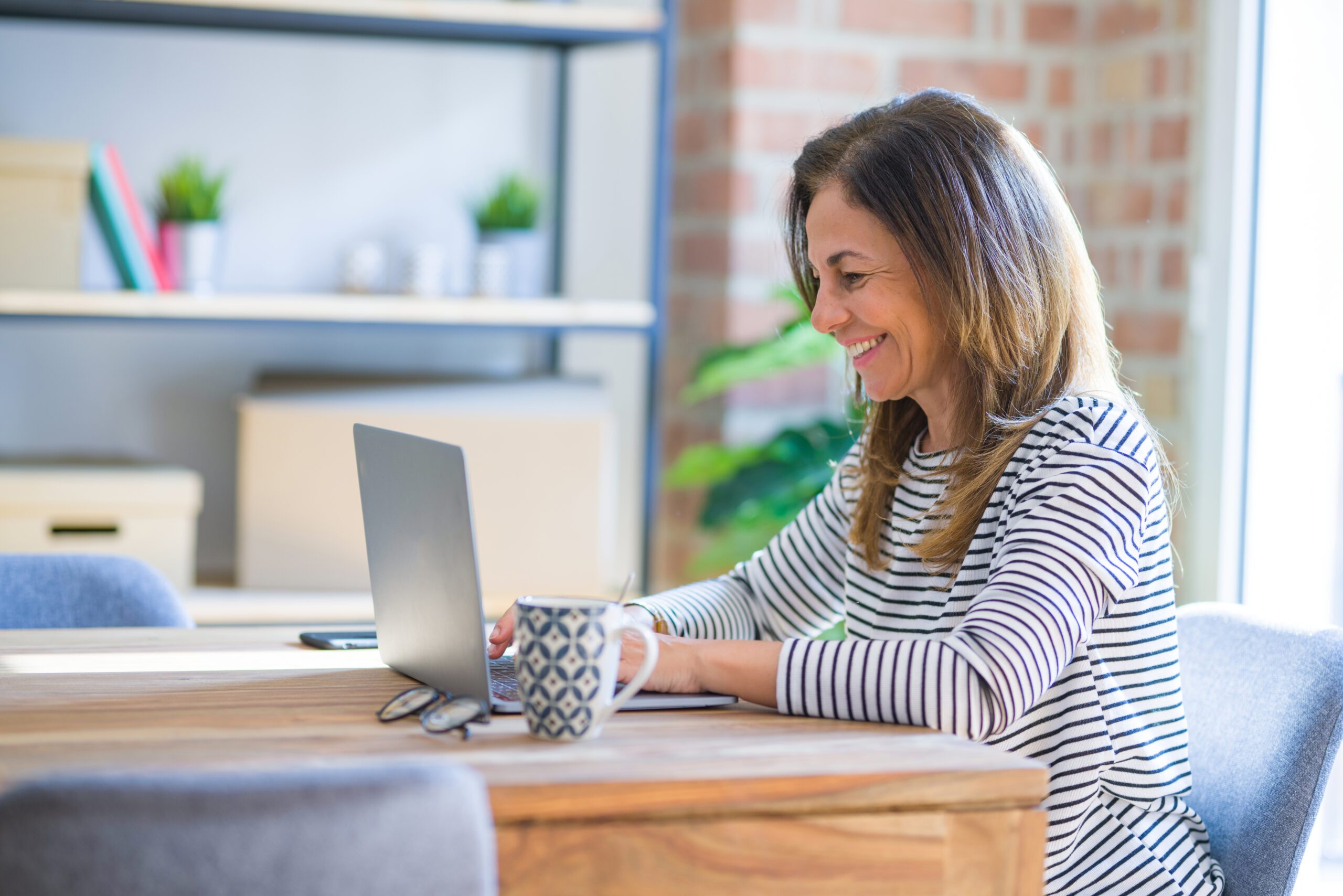 Educator Smiling While Using Laptop